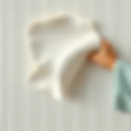 A close-up of wallpaper being gently peeled off a wall