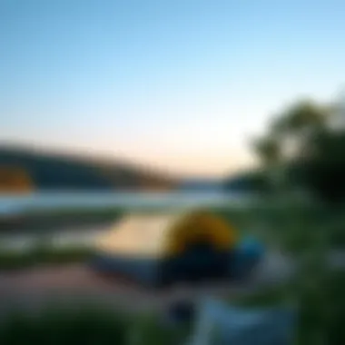 Camping tent set up by a tranquil lake surrounded by trees